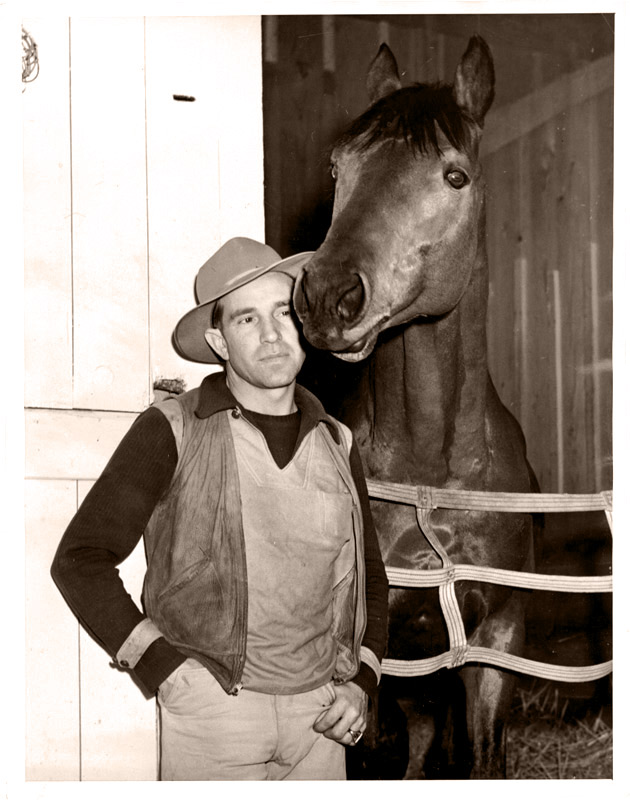 George Woolf with Seabiscuit at the stable